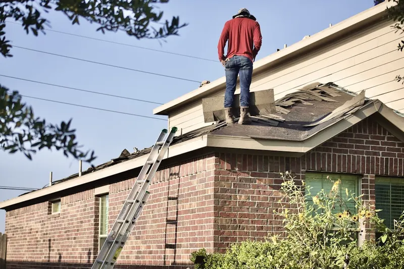 Professional roofer working on a residential roof in Brick